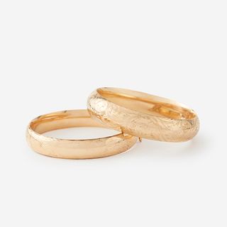 A pair of fourteen karat gold bangles,