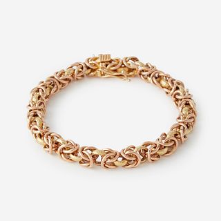 A two tone eighteen karat gold bracelet,