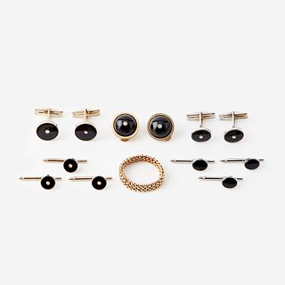Two onyx, diamond, and fourteen karat gold cufflink and stud sets with matching ear clips and a ring,