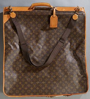 Louis Vuitton Hanging Folding Garment Bag, in brown and tan monogram coated canvas, opening to a brown nylon interior with multiple zipper compartment