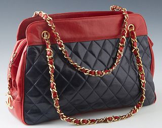 Chanel Black and Red Lambskin Chain Shoulder Bag, with gold tone hardware and zip closure, the interior of the bag lined in red leather with two zip c