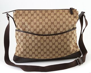 Gucci Monogrammed Canvas Large Messenger Bag, with a perforated brown calf leather bottom and front snap close pocket, the interior of the bag lined w