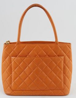 Chanel Mandarine Caviar Quilted Leather Medallion Shoulder Bag, with large "CC" logo sewn on front and golden brass zip chain with "CC" logo, opening 