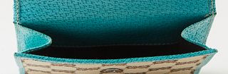 Gucci Compact GG Canvas Leather Jackie Wallet, with gun metal hardware and push release closure, the interior lined in teal leather with numerous card