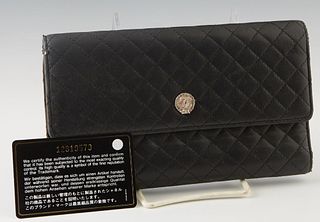 Chanel Trifold Quilted Black Leather Wallet, c. 2008, with silver hardware and a snap closure, the interior lined in baby pink leather with numerous c