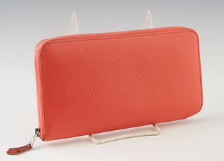 Hermes Coral Leather Zip Wallet, with silver tone hardware, the zip closure opening to a silk blend feather motif lined interior with numerous card sl