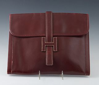 Hermes Burgundy Calfskin Jige Clutch GM Clutch, with a H slip buckle, with an beige canvas lined interior, H.- 10 3/4 in., W.- 13 1/2 in.