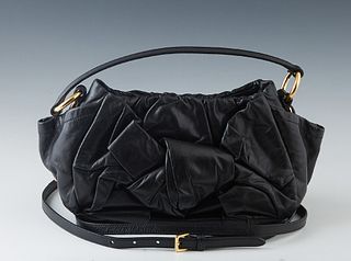 Prada Leather Shoulder Bag, the front with a ruched leather bow and two open side pockets, the exterior with gold accents, the top magnetic clasp open