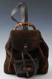 Vintage Gucci Chocolate Suede Mini Backpack, with gold-tone hardware, the peg hole and leather drawstring closure opening to a tan woven interior with