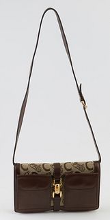 Celine Monogrammed Canvas Triple Zip Sling Bag, with an adjustable dark brown leather shoulder strap and gold hardware, the interior of the bag split 