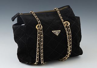 Prada Black Suede Shoulder Bag, the exterior with black quilt stitching and gold hardware, the zipper opening to a large Prada logo lined interior, wi