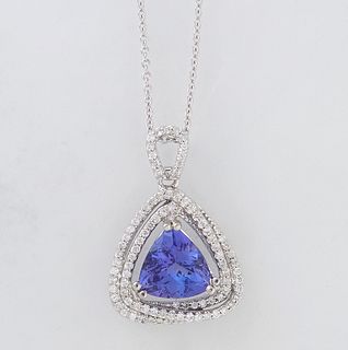 14K White Gold Pendant, with a trillion cut 3.05 ct. tanzanite, centering a double conforming border of tiny round diamonds, on a 14K white gold tiny 