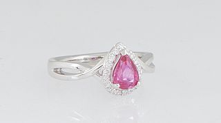 Lady's Platinum Dinner Ring, with a pear shaped untreated 1.02 ct. ruby, atop a border of tiny round diamonds, above pierced twisted shoulders of the 