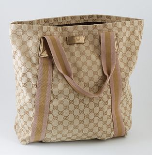 Gucci Beige and Gold Monogrammed Canvas Shopping Tote, with pink and gold striped canvas straps and gold leather accents, opening to a brown lined int