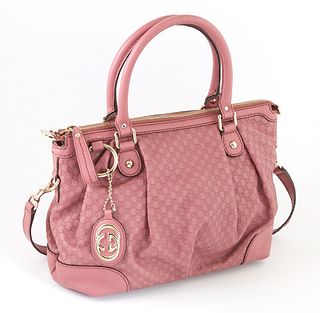Gucci Pink Micro Guccisima Leather PM Sukey Top Handle Shoulder Bag, with gold hardware and hanging Gucci charm, the exterior with a detachable and ad
