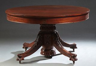 American Victorian Style Carved Mahogany Banquet Table, 20th c., the circular top on a large turned reeded baluster urn support with four acanthus car