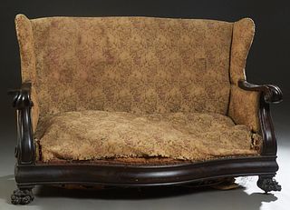 American Carved Mahogany Settee, late 19th c., the serpentine back within "wing" sides and scrolled arms, to a bowed seat, on unusual paw feet, H.- 40