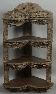 Unusual Tramp Art Leather and Wood Hanging Corner Shelf, late 19th c., carved with relief grapes, leaves and flowers, with three heart shaped shelves 