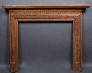 American Carved Walnut Mantel, late 19th c., the stepped top over a reeded floral carved frieze, on reeded supports, H.- 52 3/4 in., W.- 64 1/2 in., D