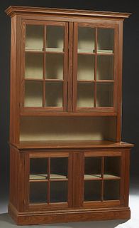 Louisiana Carved Cypress Cupboard, 20th c., the stepped crown over the upper section with double glazed mullioned doors with beaded board sides, on a 