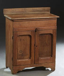 Rare Louisiana Carved Cypress Washstand, 19th c., the back splash over a rounded edge rectangular top above a frieze drawer and double cupboard doors,