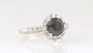 Lady's 14K White Gold Dinner Ring, with a circular 1.78 ct. black diamond atop a border of small round diamonds, the shoulders of the band also mounte