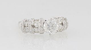 Lady's Platinum Dinner Ring, with a central 1.52 ct. round diamond, flanked by vertical bands of four round diamonds, separated by vertical bands of f