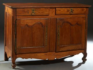 French Louis Philippe Carved Elm Sideboard, 19th c., the rounded corner ogee edge top over two frieze drawers above double cupboard doors with iron fi