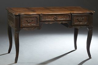 French Provincial Carved Elm Louis XV Style Desk, 19th c., the stepped serpentine parquetry inlaid top over a frieze drawer flanked by two deep drawer