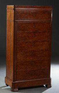 French Louis Philippe Carved Mahogany Semainier, 19th c., the canted corner top over a frieze drawer above six deep drawers, on a plinth base on stepp