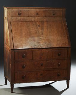 French Provincial Carved Walnut Secretary, c. 1880, the slanted edge rectangular top above a slant lid with an inset leather writing surface, opening 