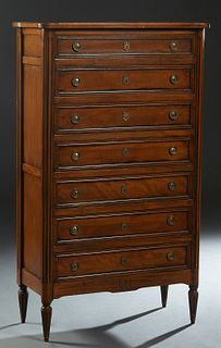 French Louis XVI Style Carved Beech Semainier, 20th c., the stepped cookie corner top over seven drawers, flanked by reeded edge pilasters, on a plint