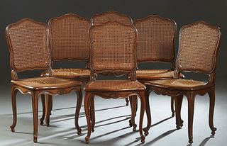 Set of Six French Louis XV Style Carved Cherry Dining Chairs, 20th c., the arched cane back over a bowed caned seat, on scrolled cabriole legs with to