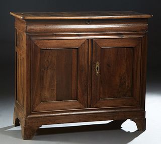 French Provincial Louis Philippe Carved Walnut Sideboard, 19th c., the rounded corner top over a long frieze drawer above double cupboard doors, on a 