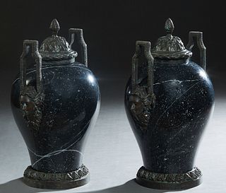 Pair of Bronze Mounted Empire Style Black Marble Covered Baluster Urns, 20th/21st c., the sides with ring mask handles, on a relief decorated circular
