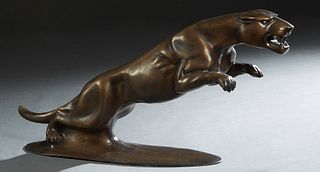 Unusual Patinated Bronze Leaping Jaguar, 20th/21st c., on a large rounded integral base, H.- 11 1/2 in., W.- 25 in., D.- 5 1/2 in.