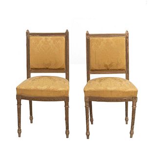 Par de sillas. Siglo XX. Estilo francés. Con respaldos cerrados y asientos en tapicería color amarillo.