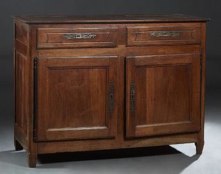 French Provincial Louis Philippe Carved Walnut Sideboard, 19th c., the canted corner top over two frieze drawers and double cupboard doors with long i