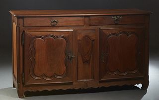 Louis XV Style Carved Elm and Walnut Louis XV Style Sideboard, the rounded edge and corner top over two frieze drawers above double fielded panel cupb