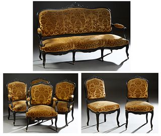 French Seven Piece Ebonized Carved Beech Parlor Suite, c. 1870, composed of a settee, 4 fauteuils, and 2 side chairs