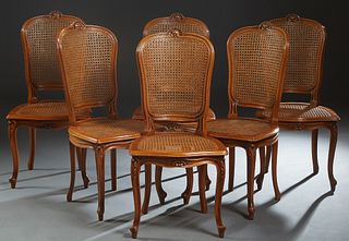Set of Six Louis XV Style Carved Cherry Dining Chairs, 20th c., the arched curved caned back with a shell surmount, to a stepped caned seat, on scroll