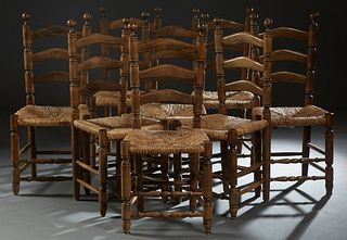 Set of Eight French Provincial Carved Beech Rush Seat Dining Chairs, 20th c., the arched ladderbacks over woven rush seats on turned tapered legs, joi
