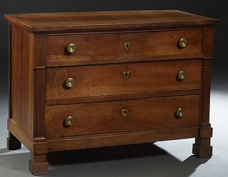 French Empire Style Carved Walnut Commode, 19th c., the rectangular top over a frieze drawer and two setback lower drawers flanked by applied pilaster