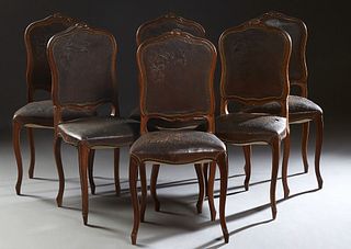 Set of Six Louis XV Style Carved Walnut Dining Chairs, late 19th c., the serpentine shell carved crest rail over a shield shaped embossed leather back