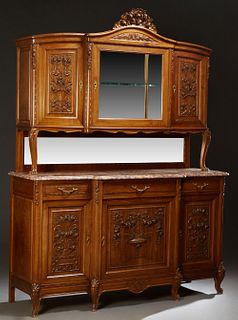French Carved Walnut Louis XV Style Marble Top Sideboard, c. 1910, the arched floral and leaf carved crown over a central wide beveled glazed door cab