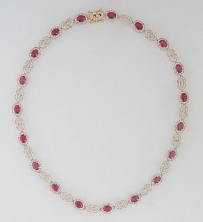 14K Yellow Gold Link Necklace, the nineteen links mounted with an oval ruby atop a border of round diamonds, joined by pierced diamond mounted double 