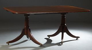 Georgian Style Banded Mahogany Double Pedestal Dining Table, early 20th c., the reeded edge rounded corner top on two tapered turned supports with tri