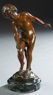 After Auguste Moreau (French), "Boy Playing Marbles," early 20th c., patinated bronze, on a stepped verde antico circular base, H.- 10 1/2 in., W.- 6 