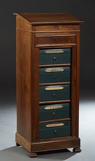 French Louis Philippe Carved Walnut Sidelock File Cabinet, late 19th c., the slanted opening lectern top over a frieze drawer and five removable cardb