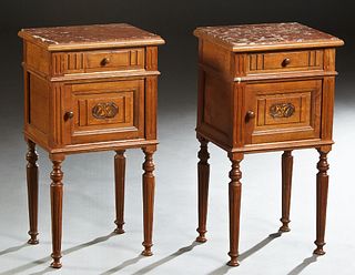 Pair of Louis Philippe Carved Walnut Marble Top Nightstands, 19th c., the inset highly figured brown marble over a frieze drawer and a pot cupboard, o